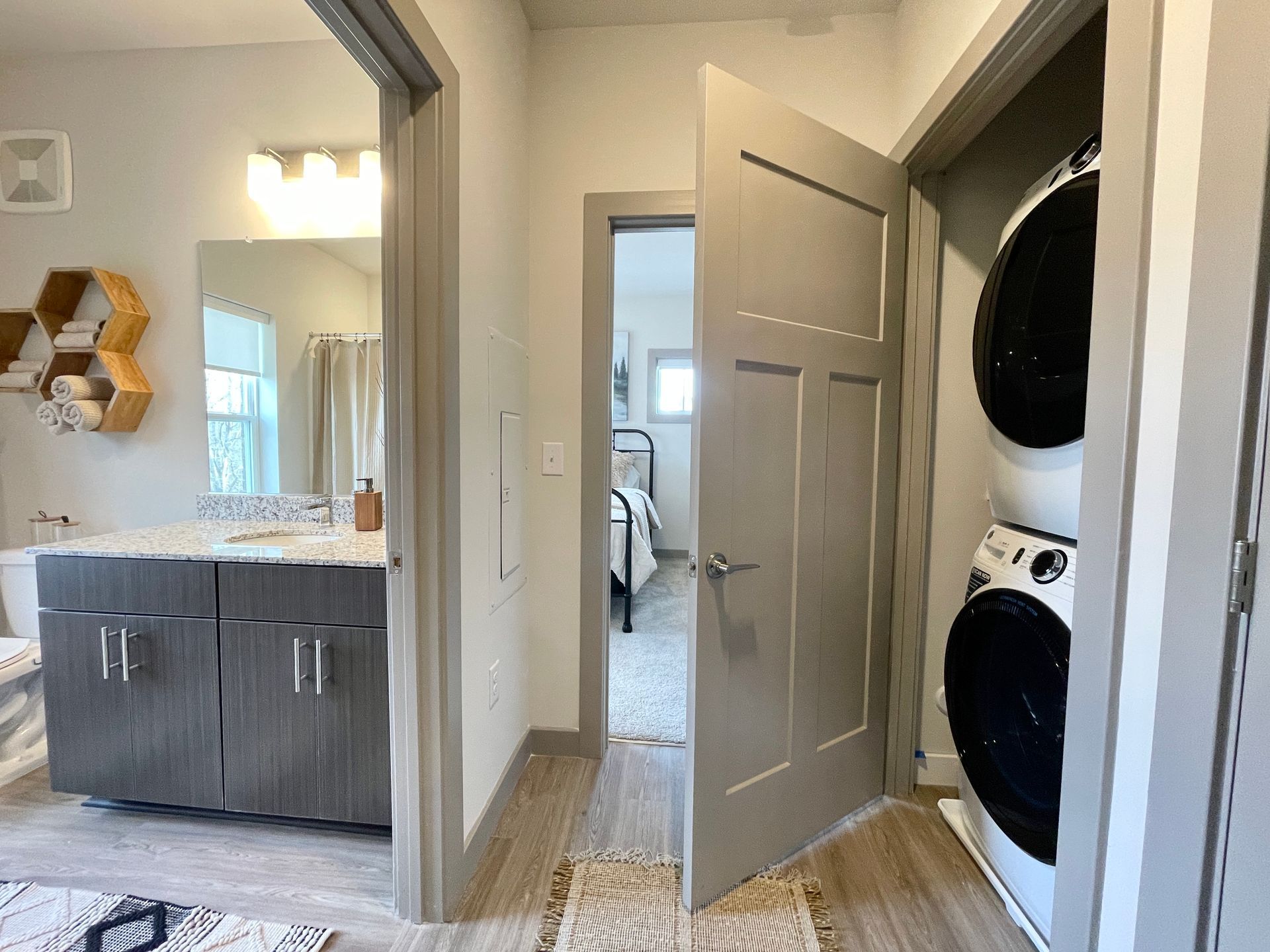 A laundry room with a washer and dryer stacked on top of each other.