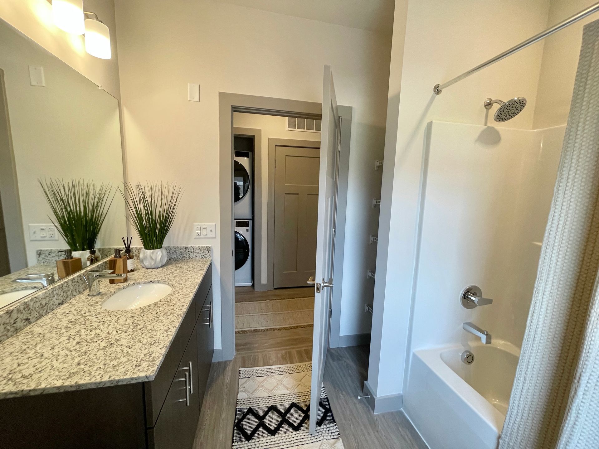 A bathroom with two sinks , a tub , and a shower.