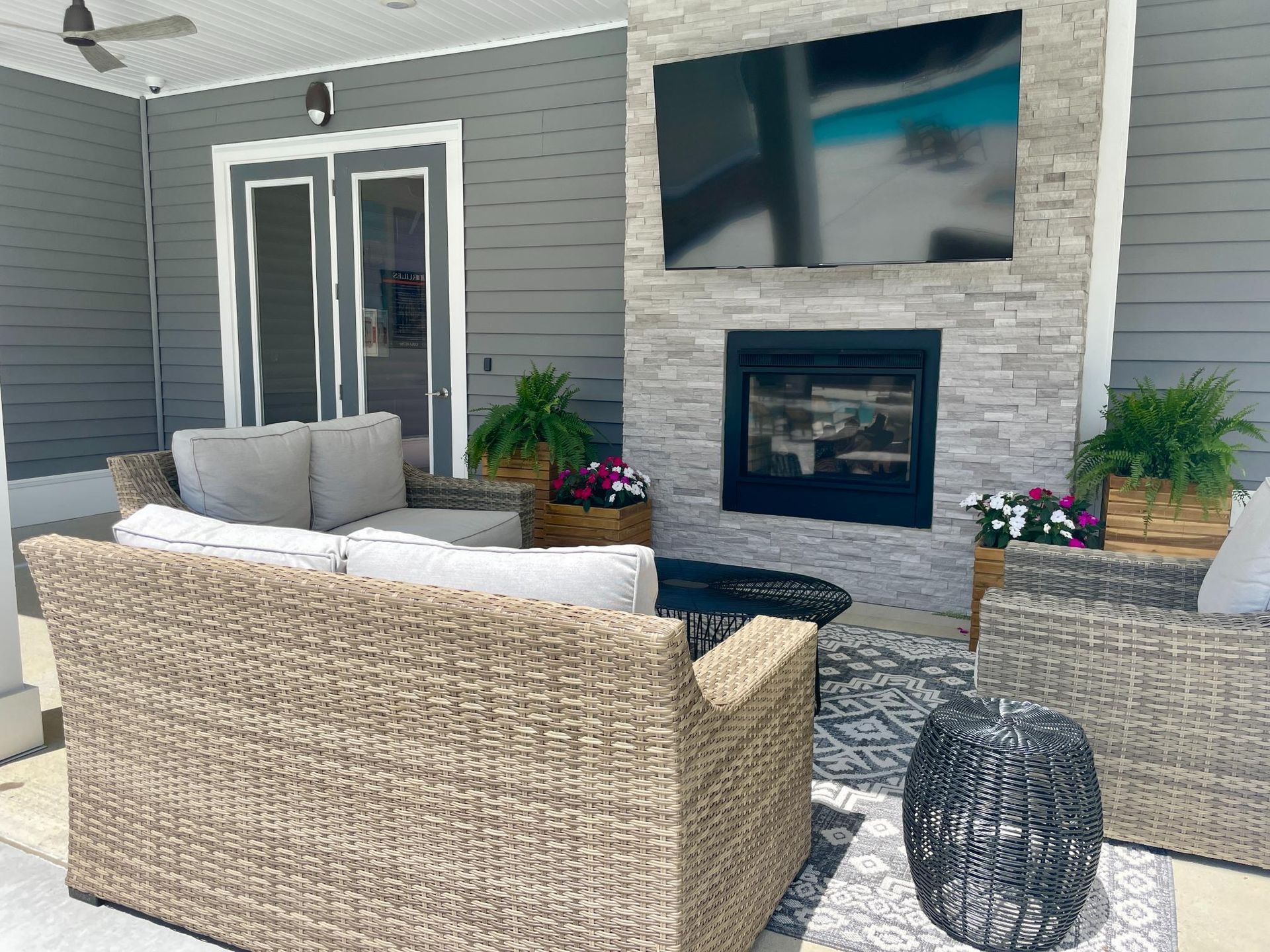 A living room with a fireplace and a flat screen tv.