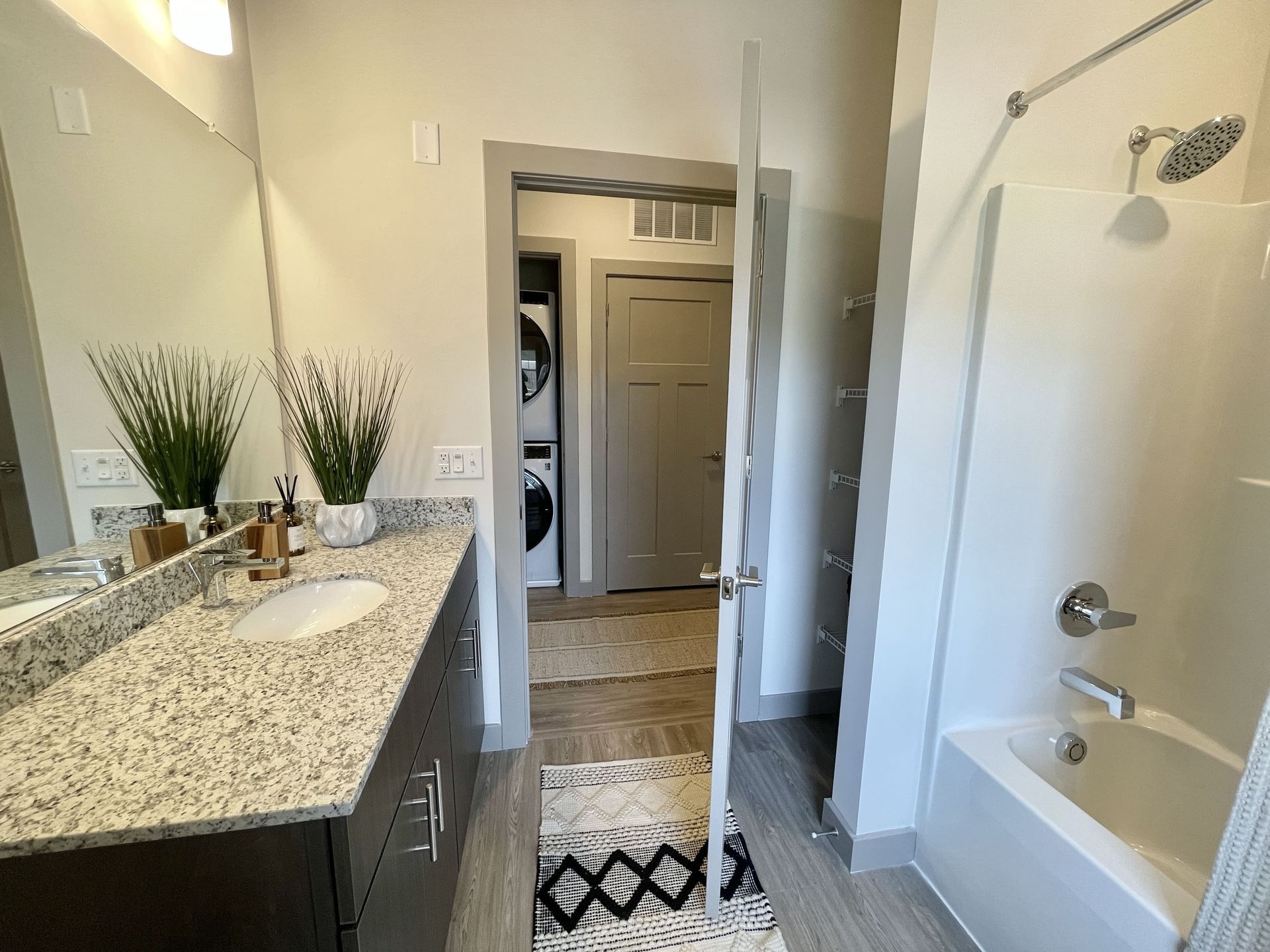 A bathroom with a sink , tub and shower.