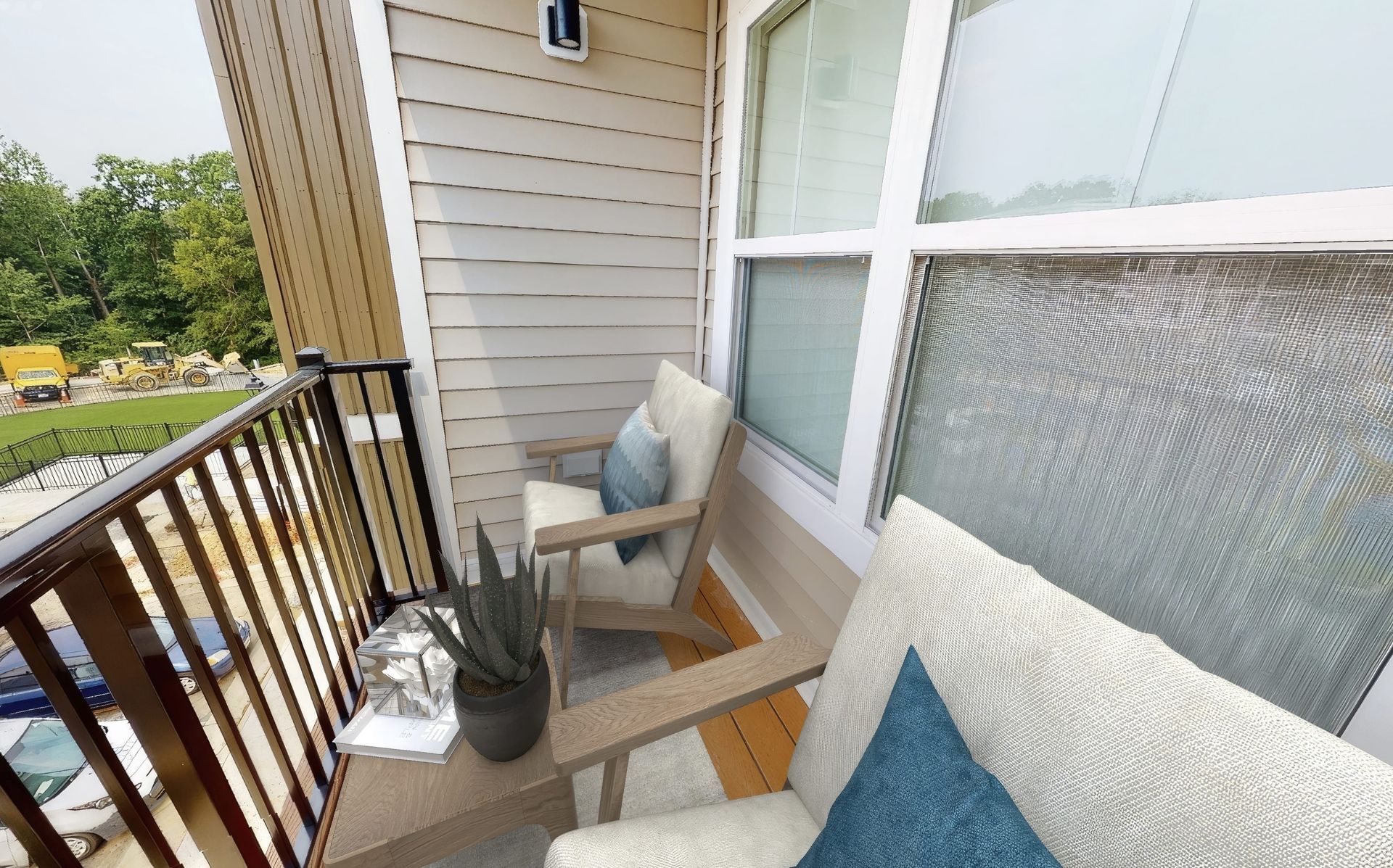 There is a balcony with a couch and chairs on it.