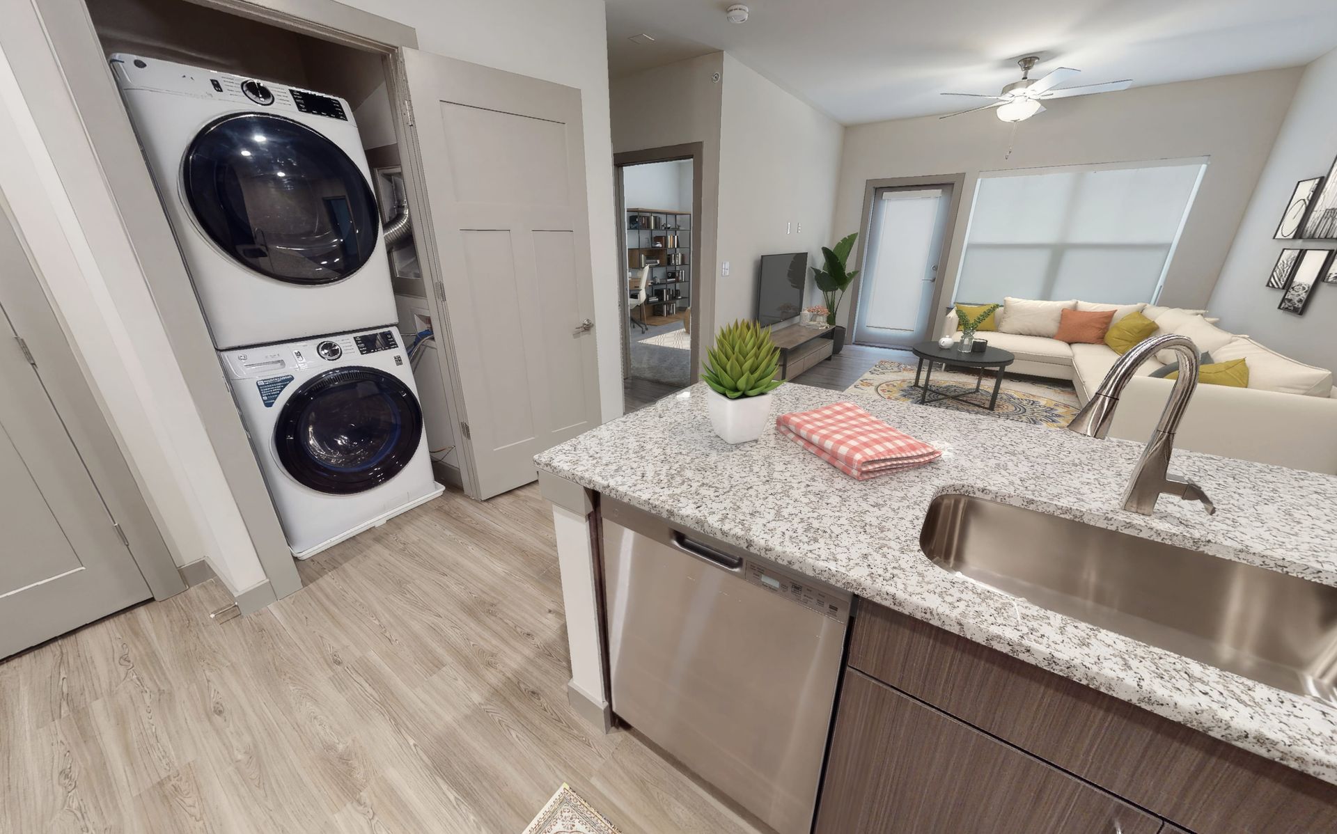 A washer and dryer are stacked on top of each other in a laundry room.
