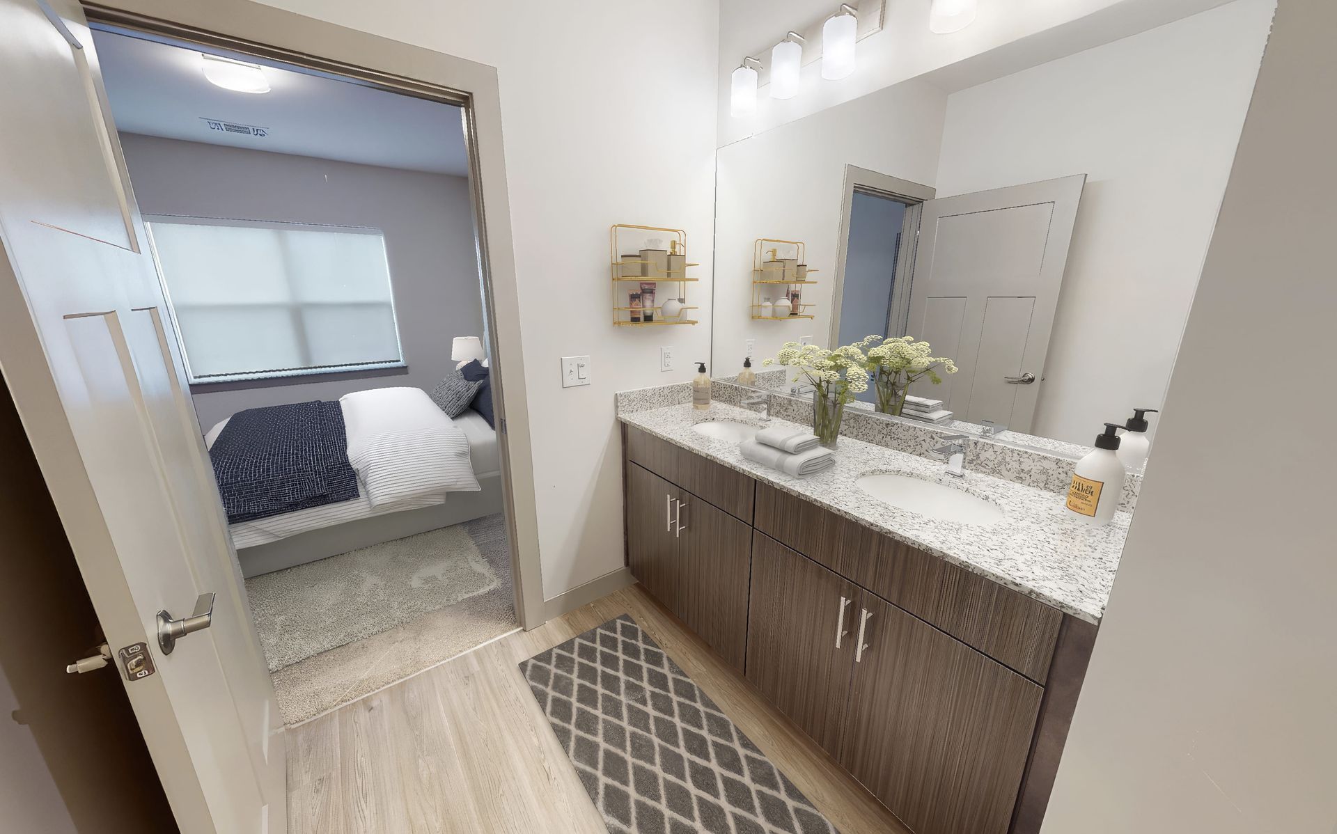 A bathroom with a double sink and a large mirror.