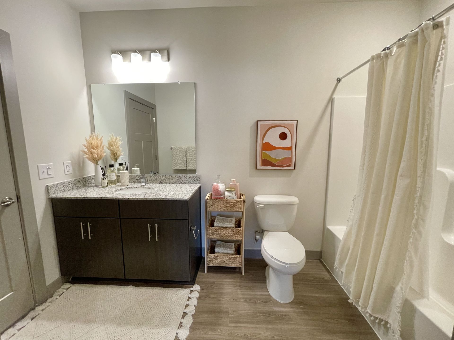 A bathroom with a toilet , sink , and shower curtain.