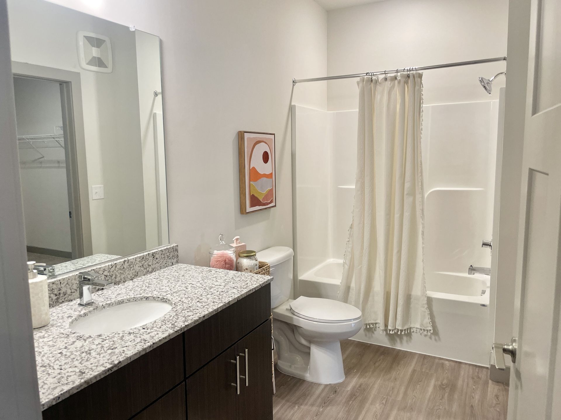 A bathroom with a sink , toilet , tub and shower.