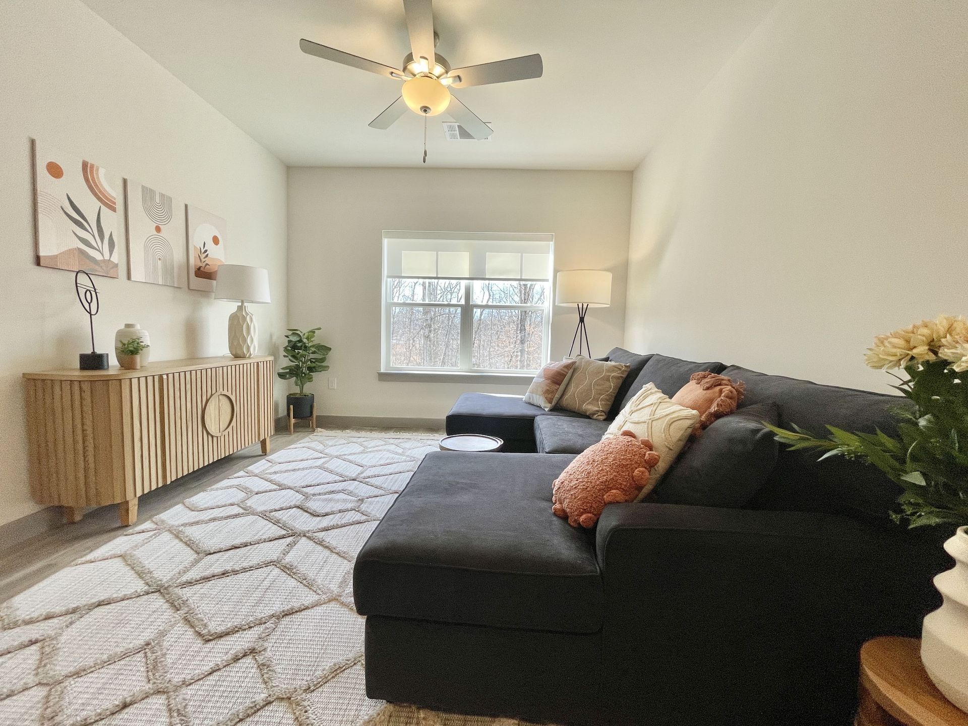 A living room with a couch and a ceiling fan