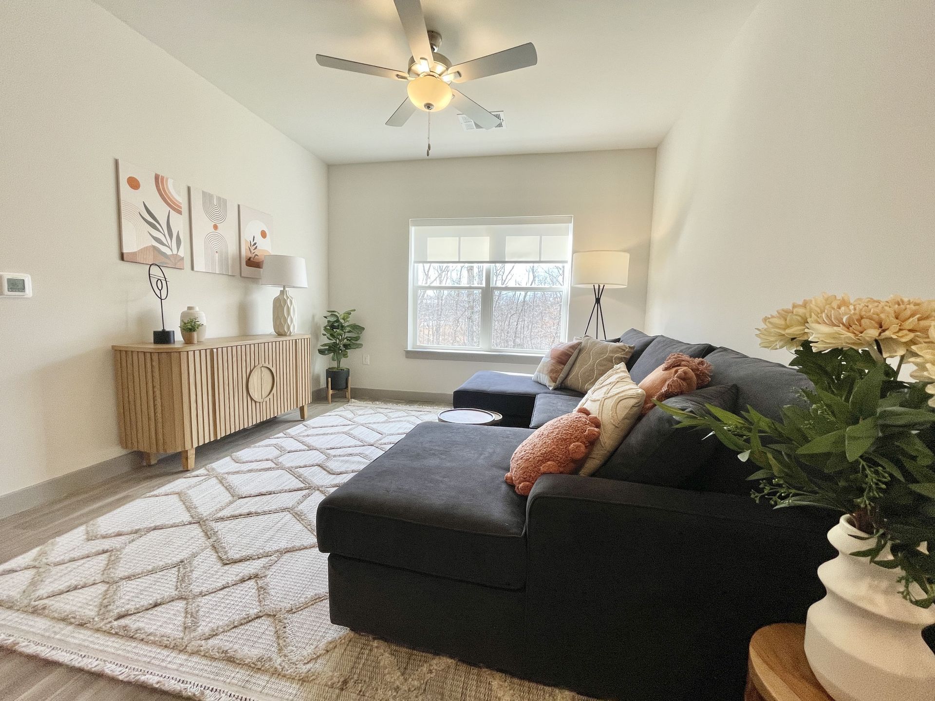 A living room with a couch and a ceiling fan