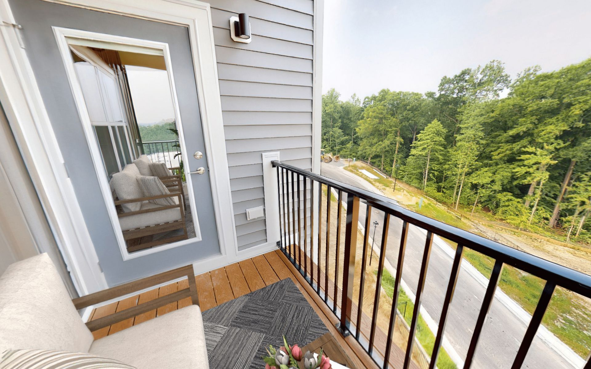 There is a balcony with a couch and a table on it.