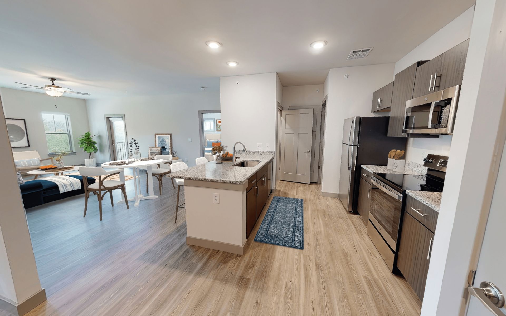 A 3d model of a kitchen and living room in a house.