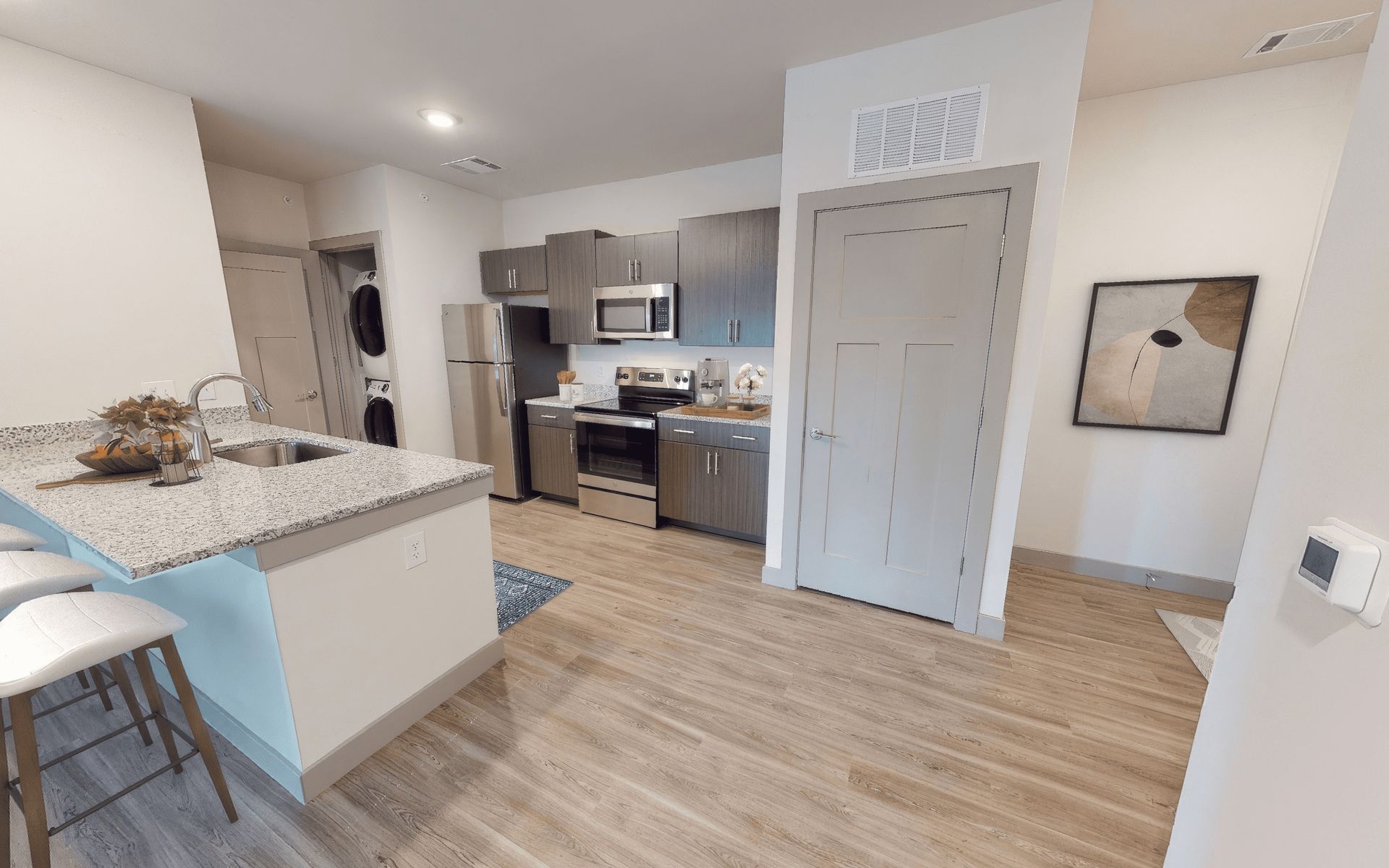 A 3d model of a kitchen with stainless steel appliances and granite counter tops.