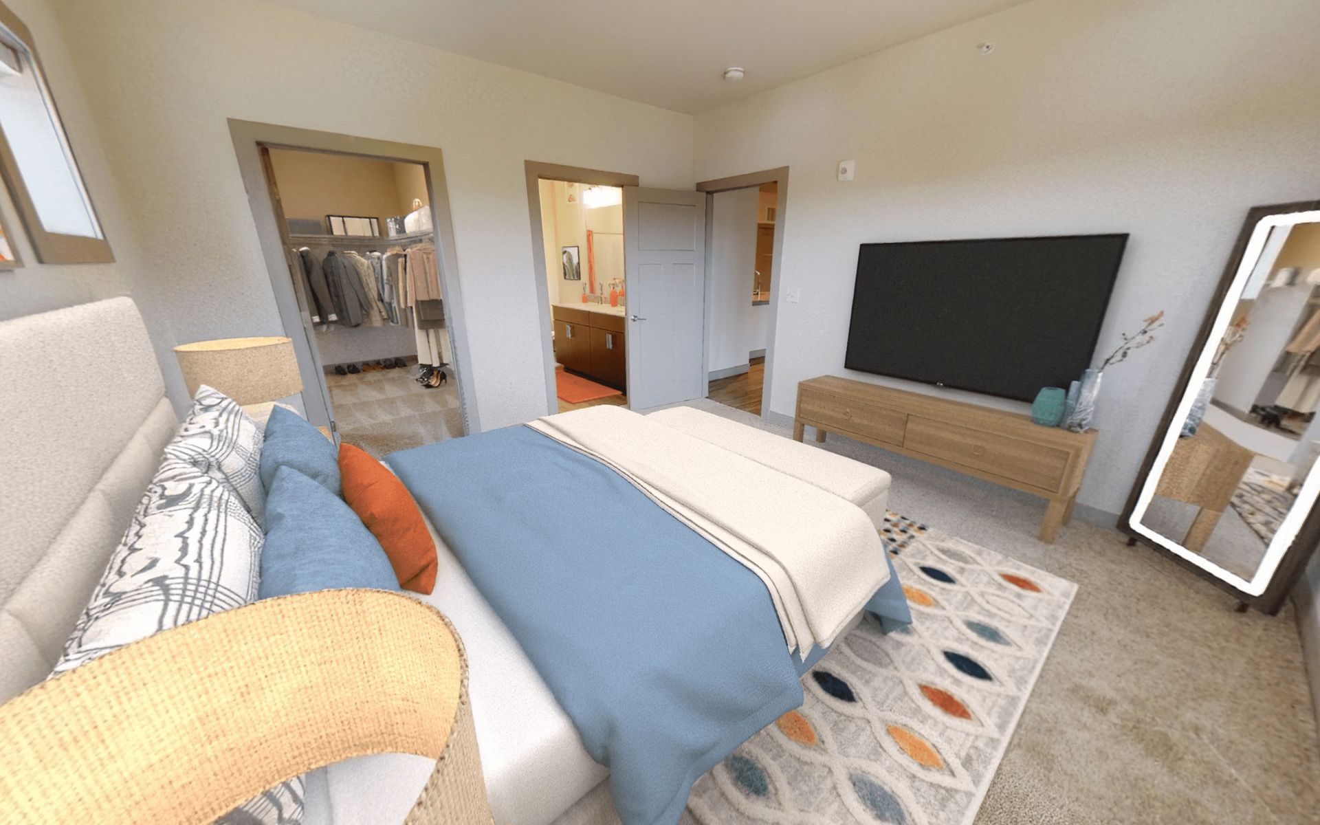 A bedroom with a bed , television , and mirror.