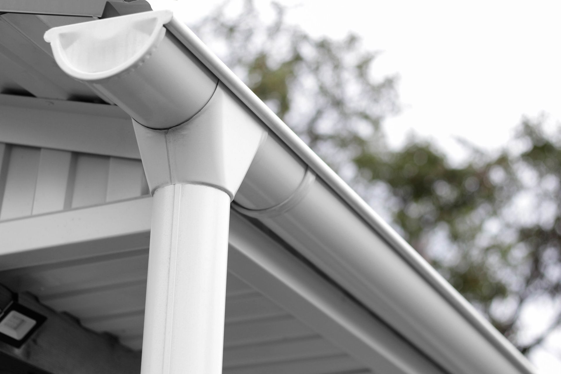 White gutter system on a building, directing rainwater