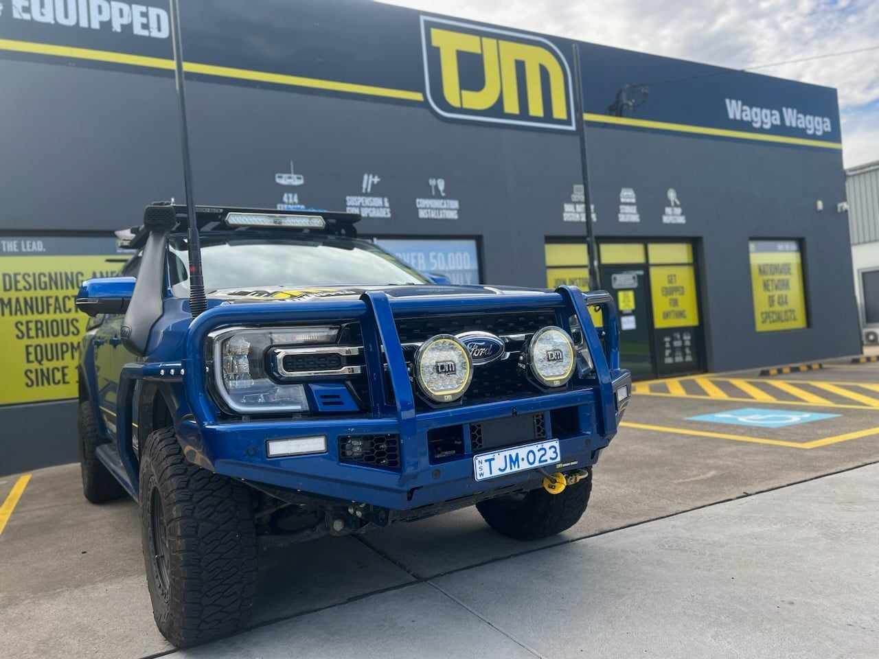 Blue Ford Truck With Custom Off-road Bumper Parked — TJM Wagga Wagga In Ashmont, NSW 