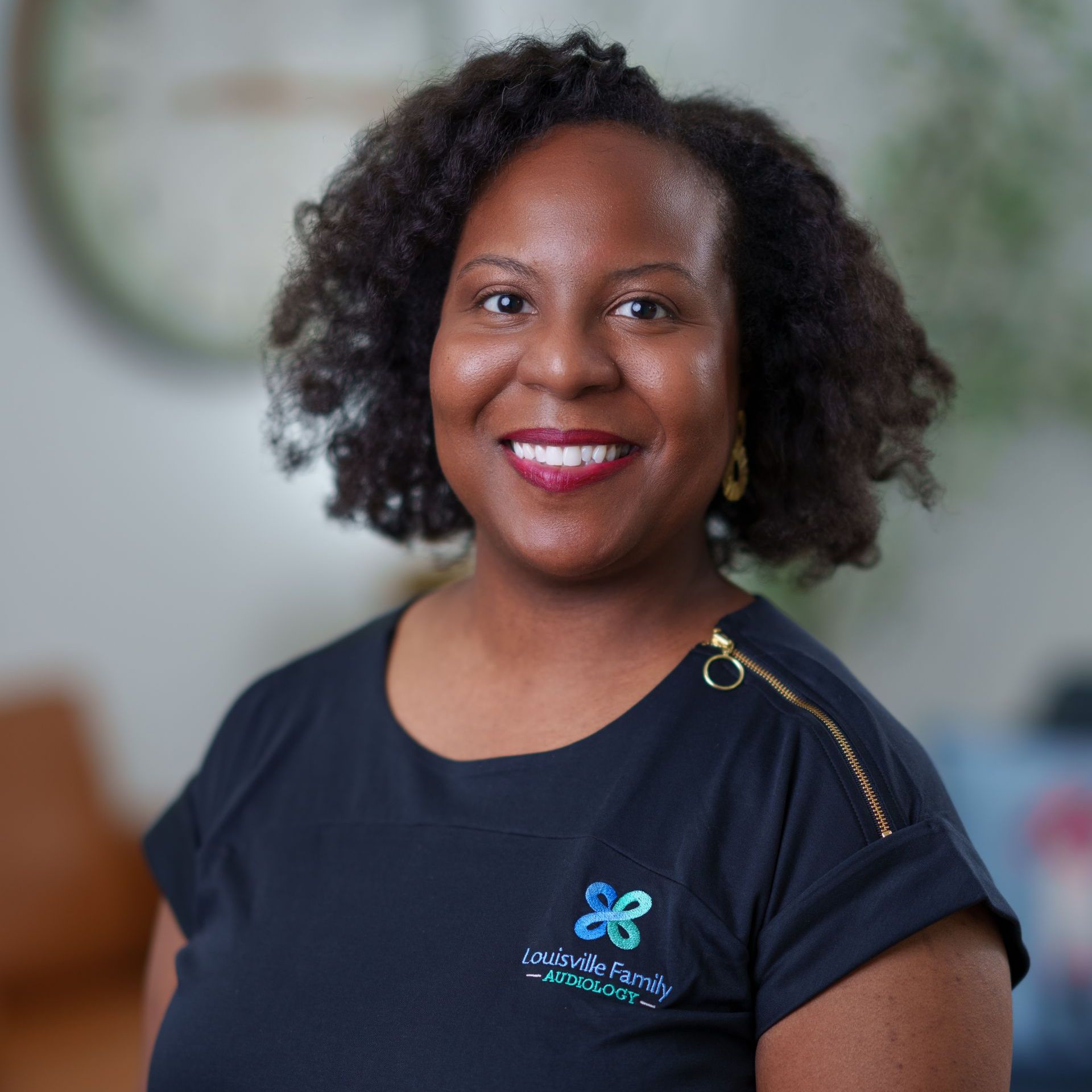 A woman wearing a black shirt with a blue butterfly on it