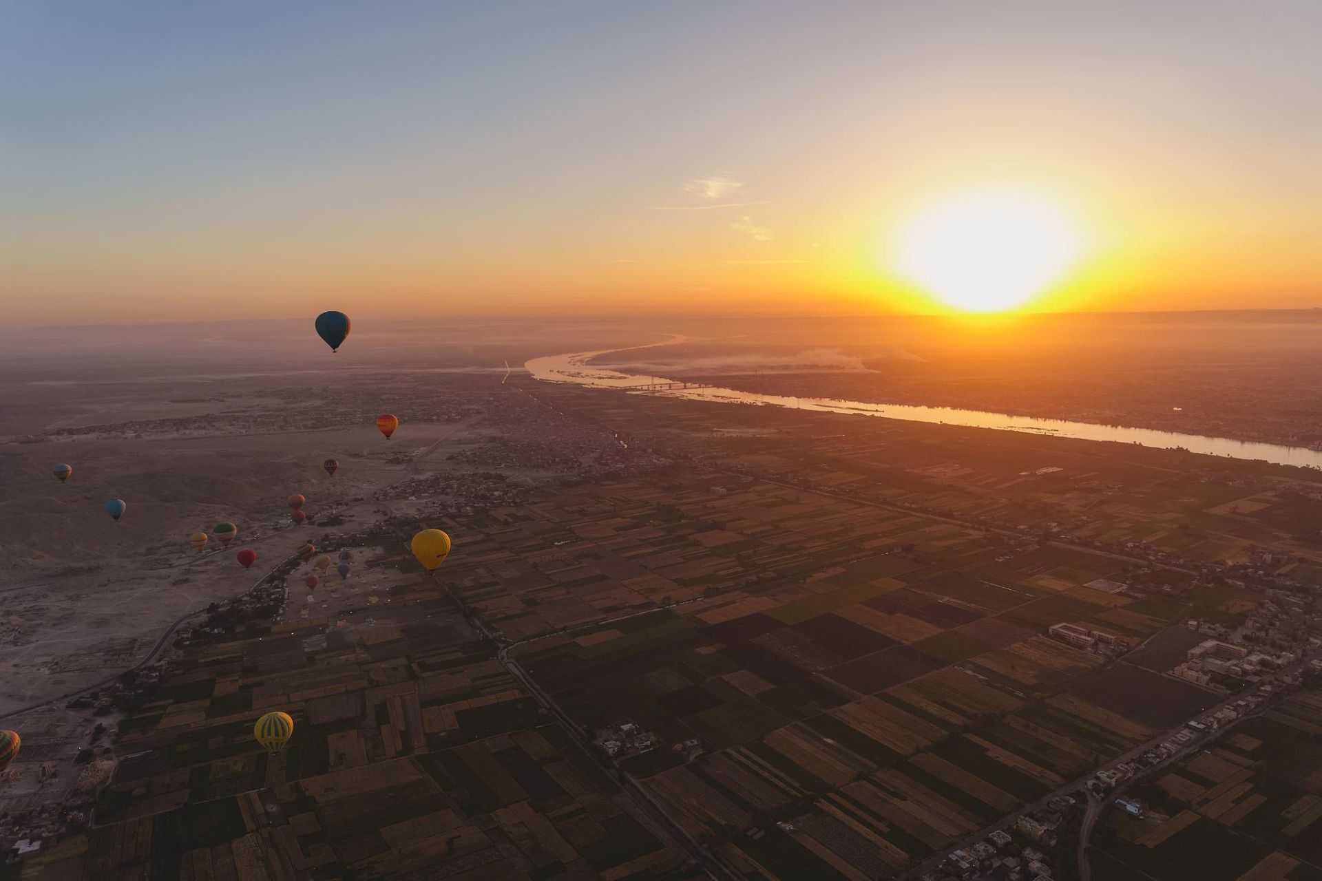 Hot air balloon over Luxor West Bank at sunrise