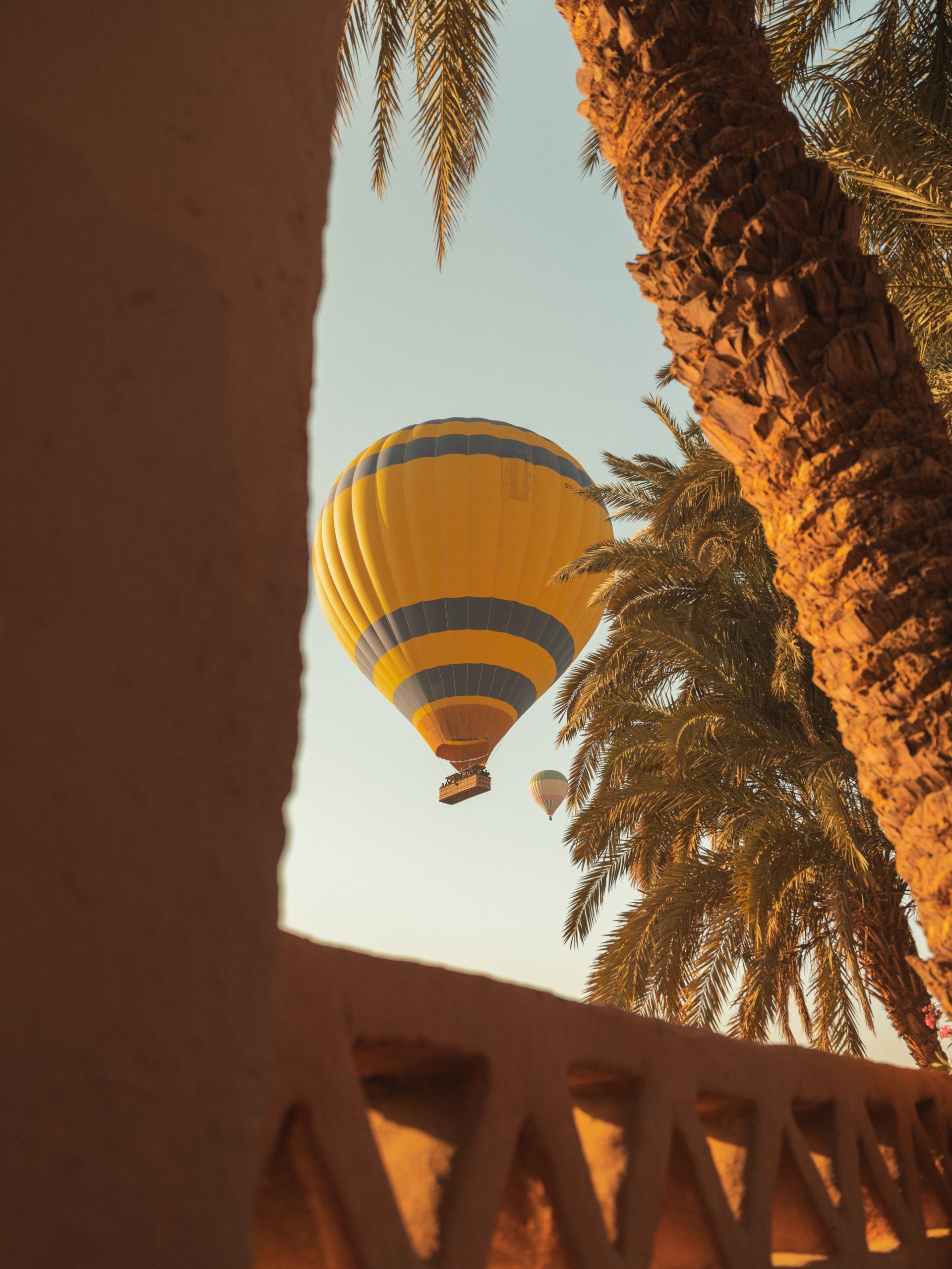 Multiple hot air balloons flying over Luxor