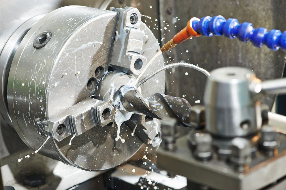 A Machine Is Cutting A Piece Of Metal On A Lathe — Wallers Precision Tooling In Paget , QLD