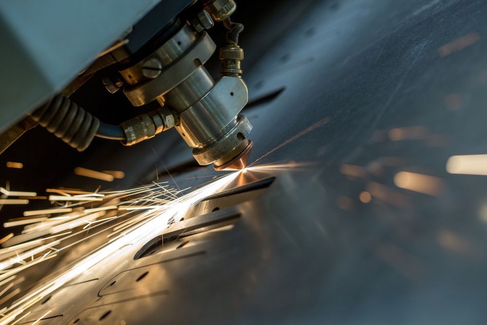 A Machine Is Cutting A Piece Of Metal With Sparks Coming Out Of It — Wallers Precision Tooling  In Mackay, QLD