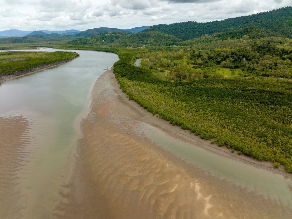 An Aerial View Of A River Surrounded By Trees And Mountains — Wallers Precision Tooling  In Proserpine, QLD