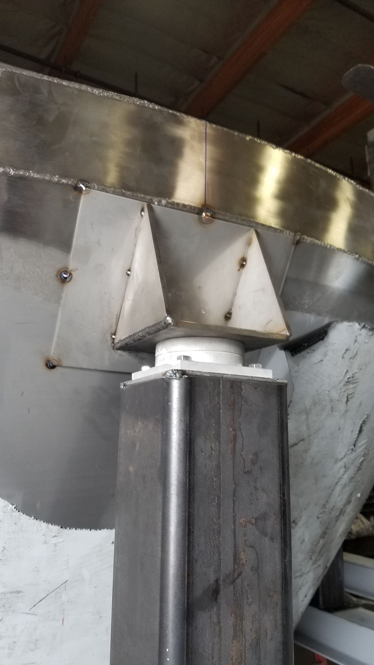 A person is welding a piece of metal with sparks coming out of it.