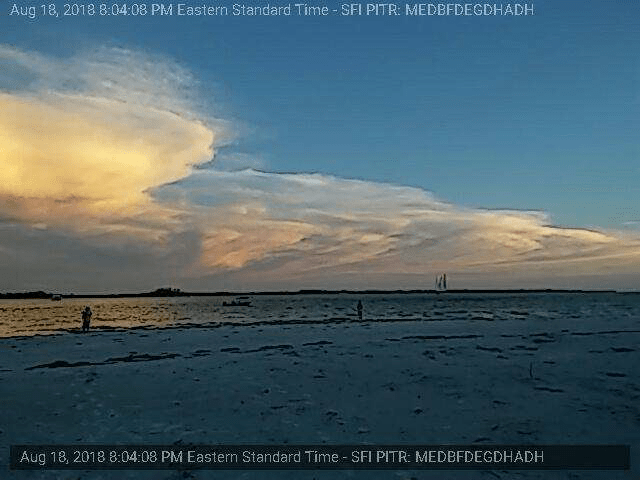 A picture of a cloudy sky over a body of water.