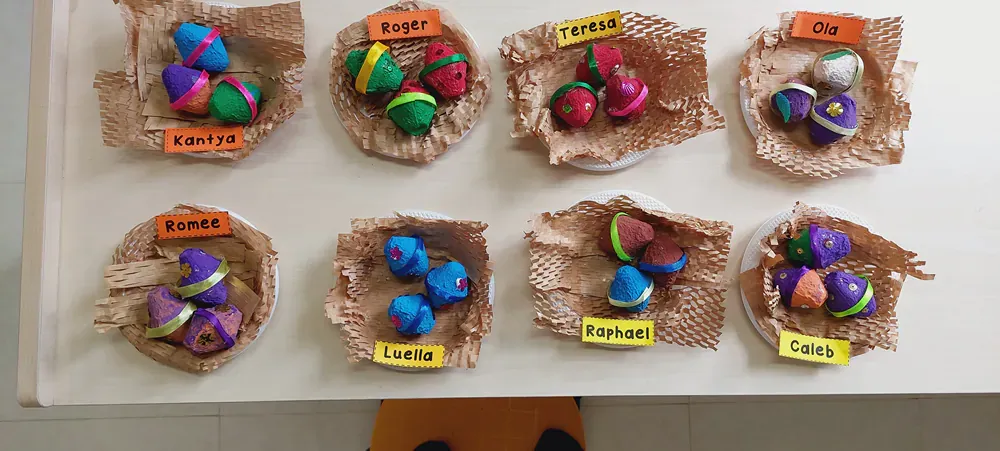 A table with a bunch of colorful eggs on it