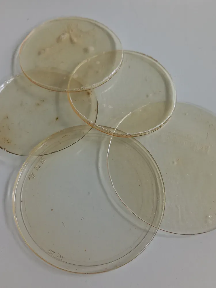 A bunch of plastic plates are stacked on top of each other