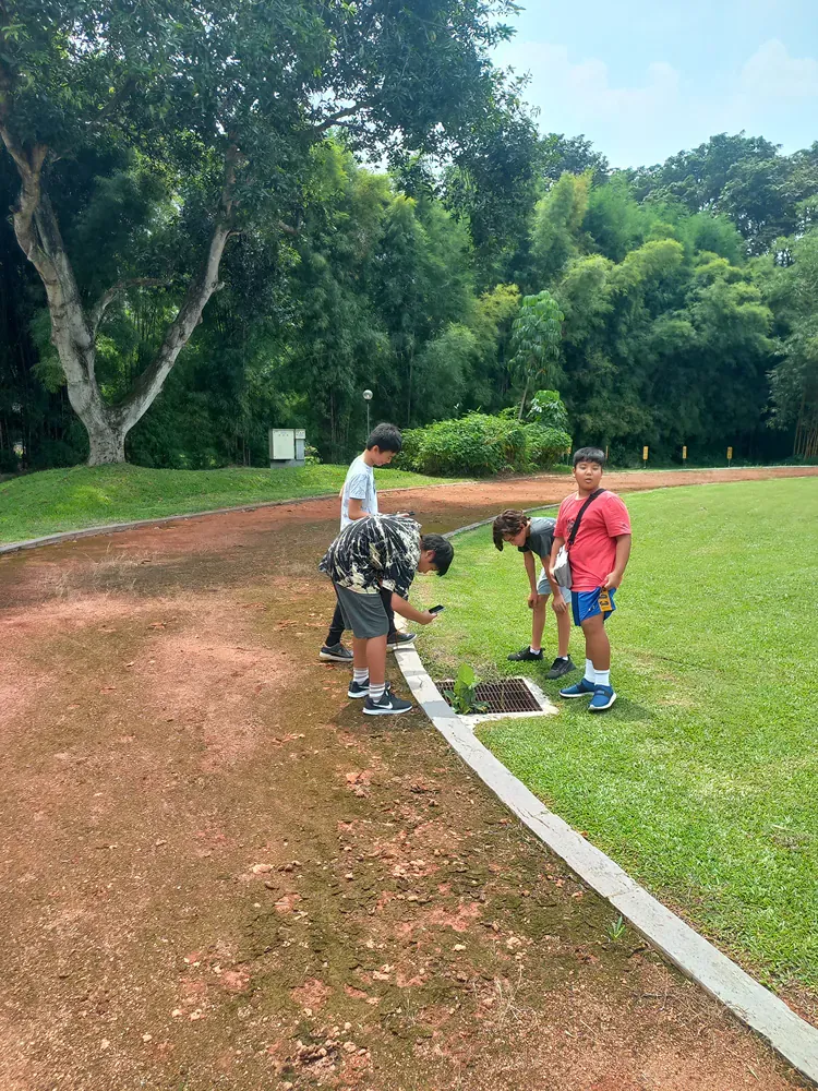 A group of people are working on a track in a park.