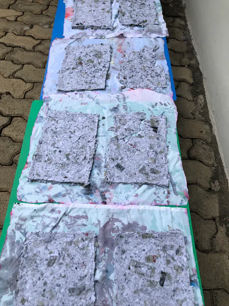 A row of squares sitting on top of each other on a brick sidewalk.