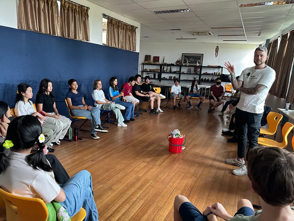 A group of people are sitting in a circle in a room.