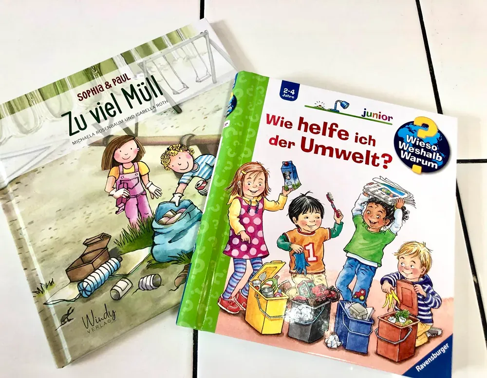 Two children 's books are sitting on top of each other on a table.