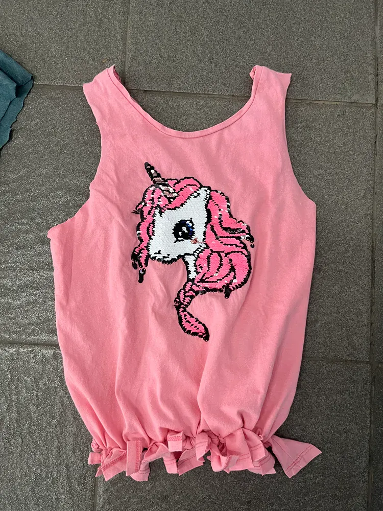 A pink tank top with a unicorn on it