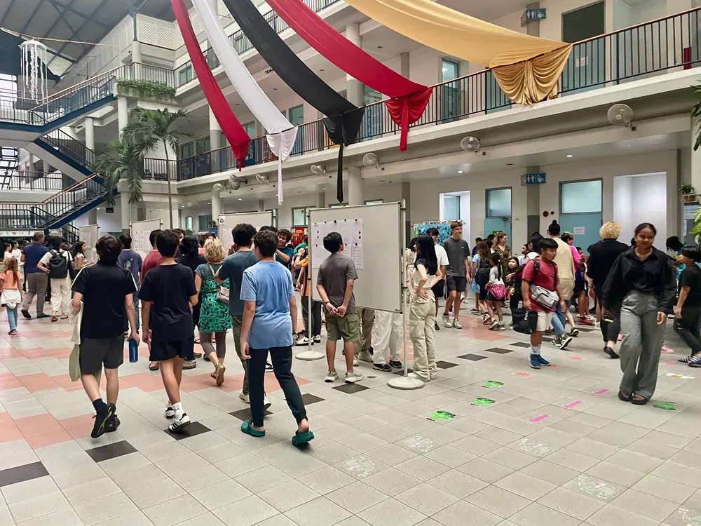 A large group of people are walking through a building.