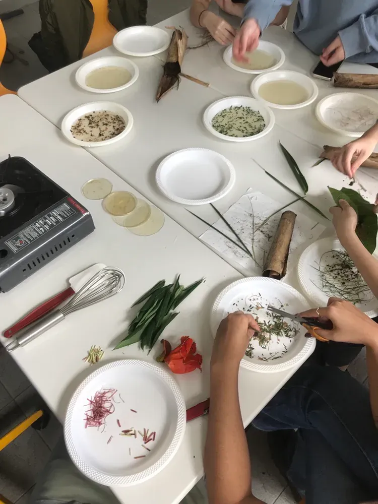 A group of people are sitting at a table with plates of food.