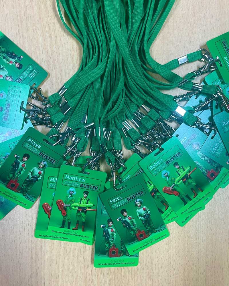 A bunch of green id cards are laying on a table