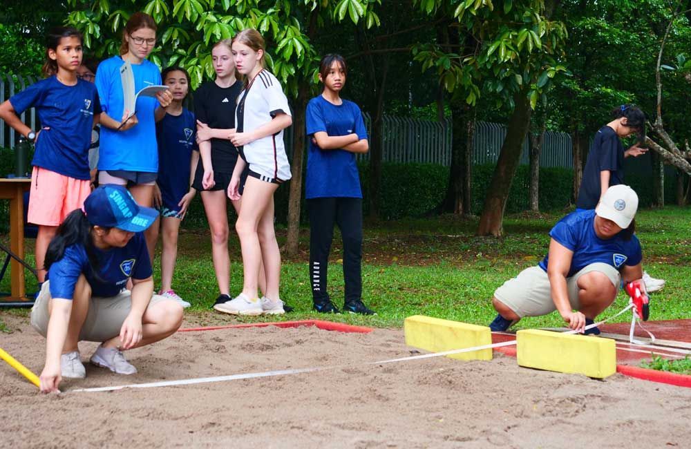 A group of people are playing a game in the dirt.
