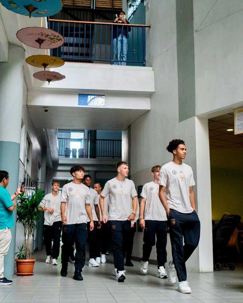 A group of young men are walking down a hallway