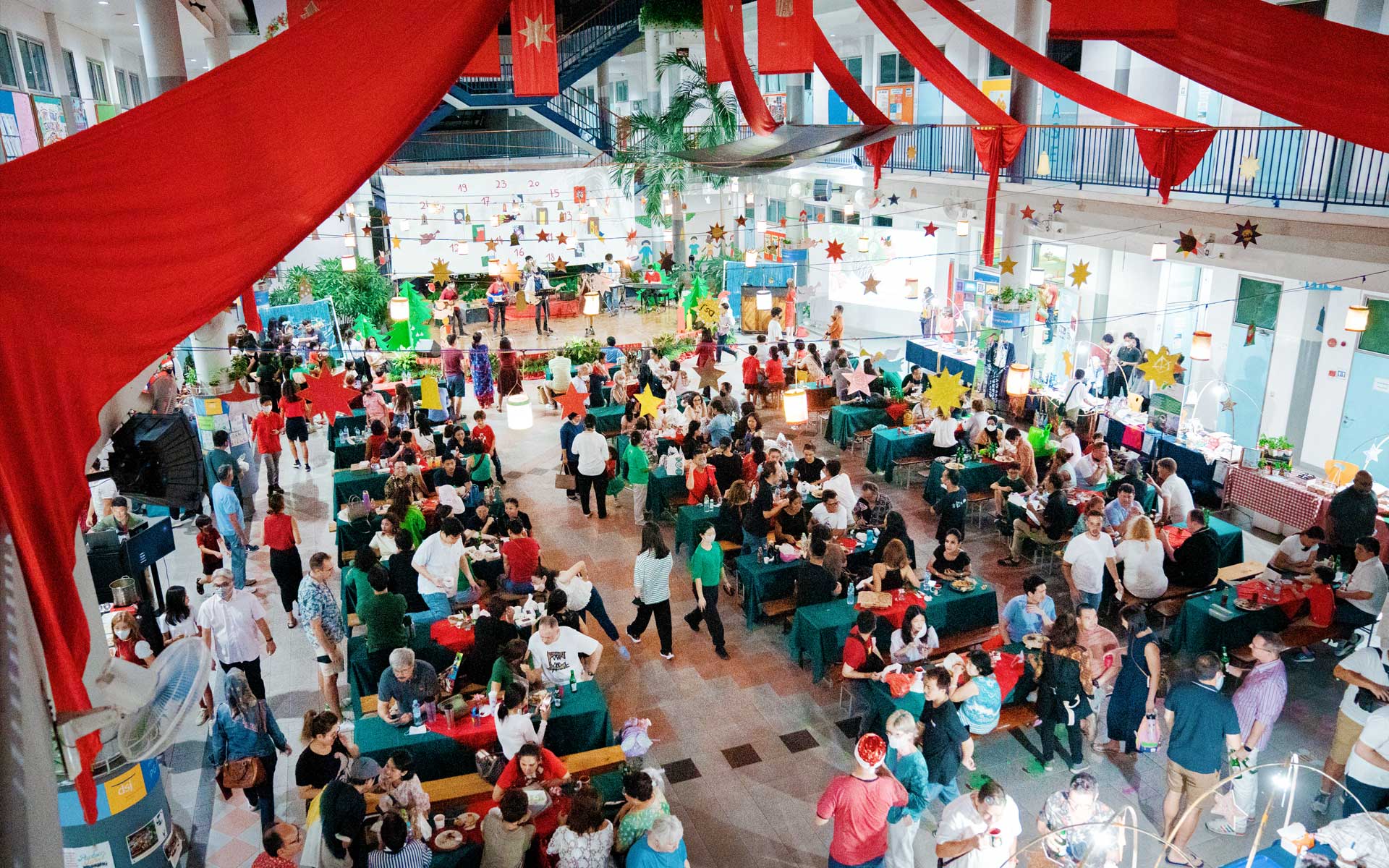 A large group of people are sitting at tables in a large room.