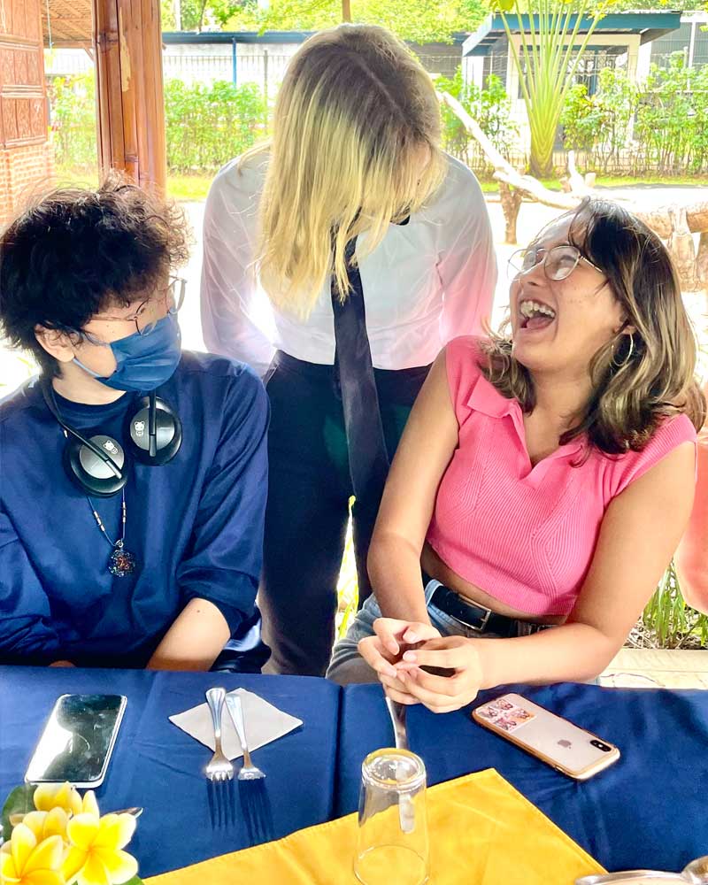 A group of people are sitting at a table laughing.