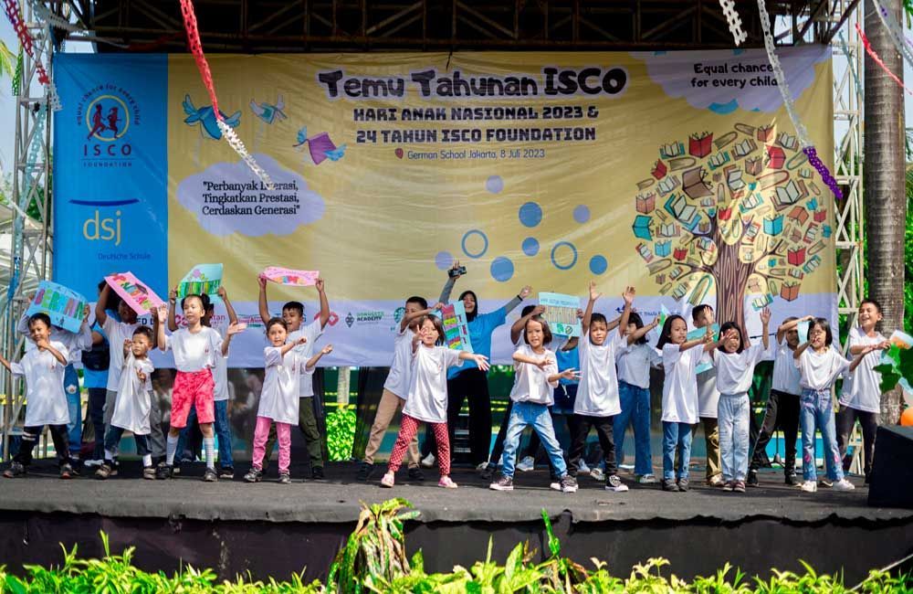 A group of children are dancing on a stage.