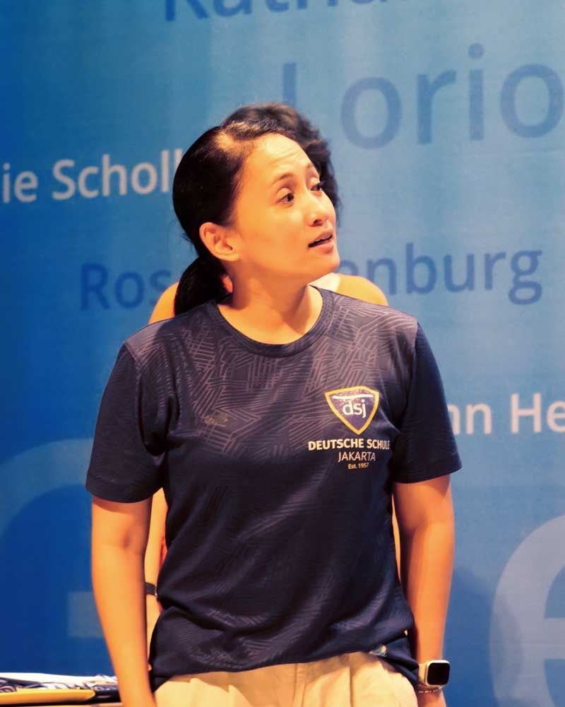 A woman wearing a t-shirt that says deutsches kreuz