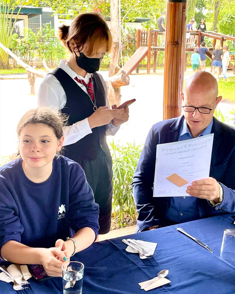A man and a woman are sitting at a table in a restaurant.