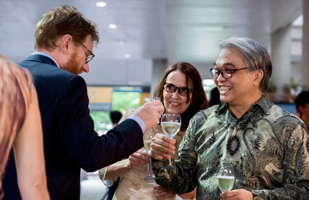 A group of people are toasting with champagne glasses at a party.