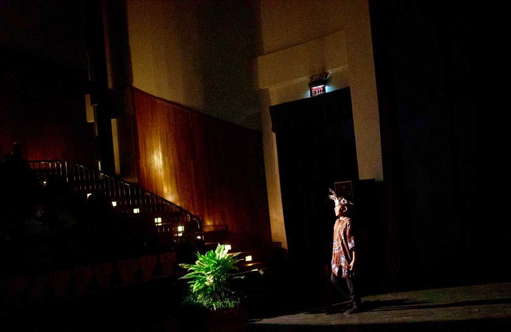 A person is standing in the dark in a dark room.