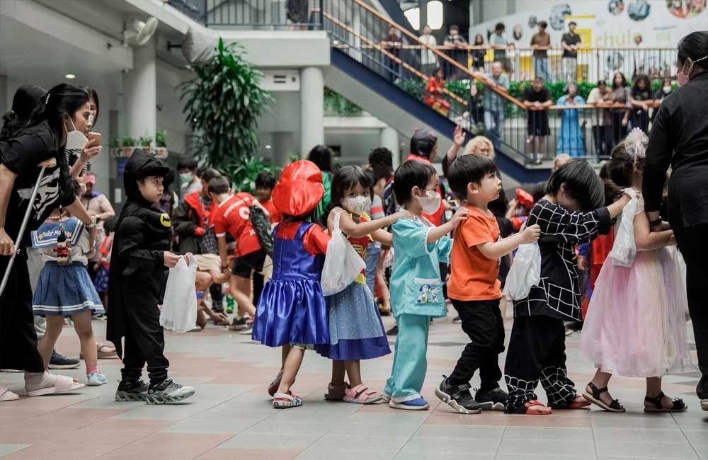 A group of children dressed in costumes are standing in a line.