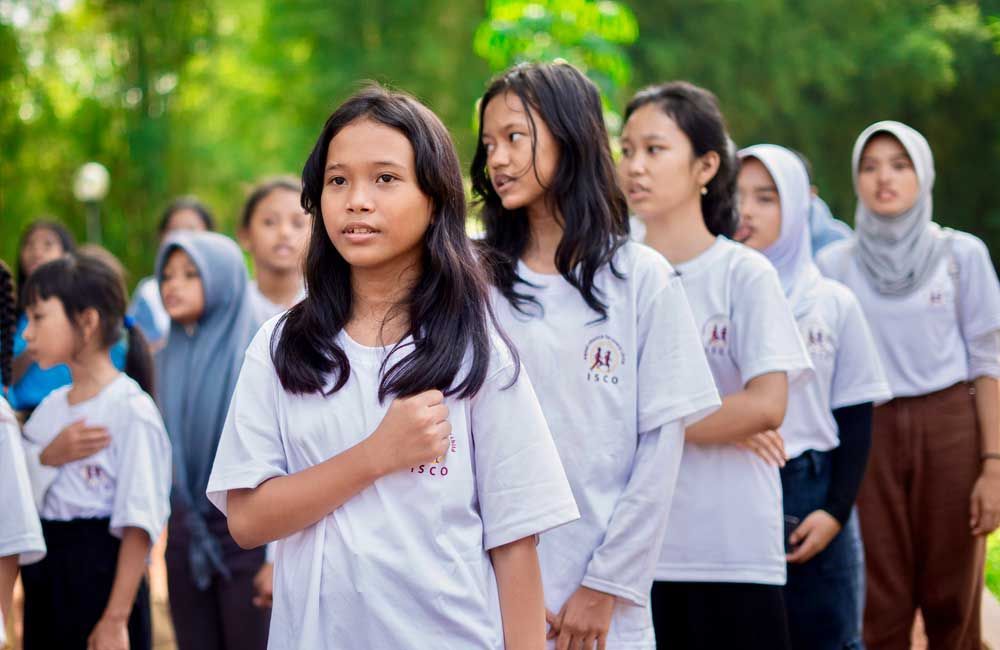 A group of young girls are standing in a line.