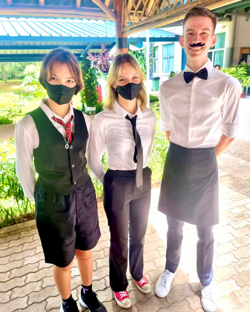 A group of people wearing masks and bow ties are standing next to each other.