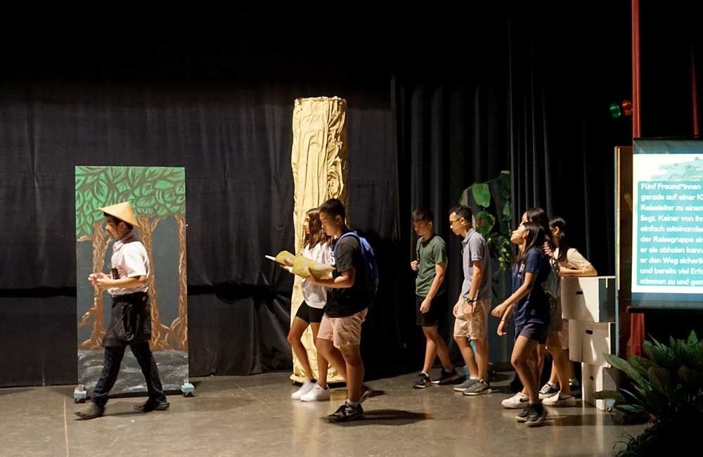 A group of people are standing in a line on a stage.