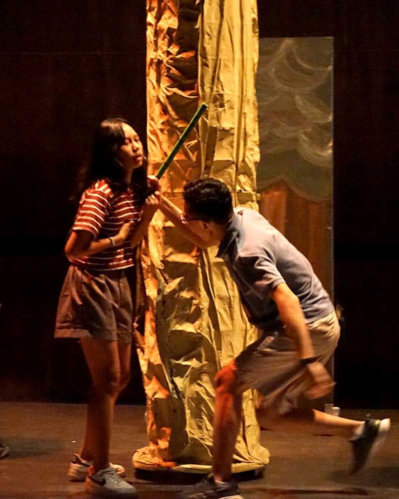 A man and a woman are standing next to each other on a stage.