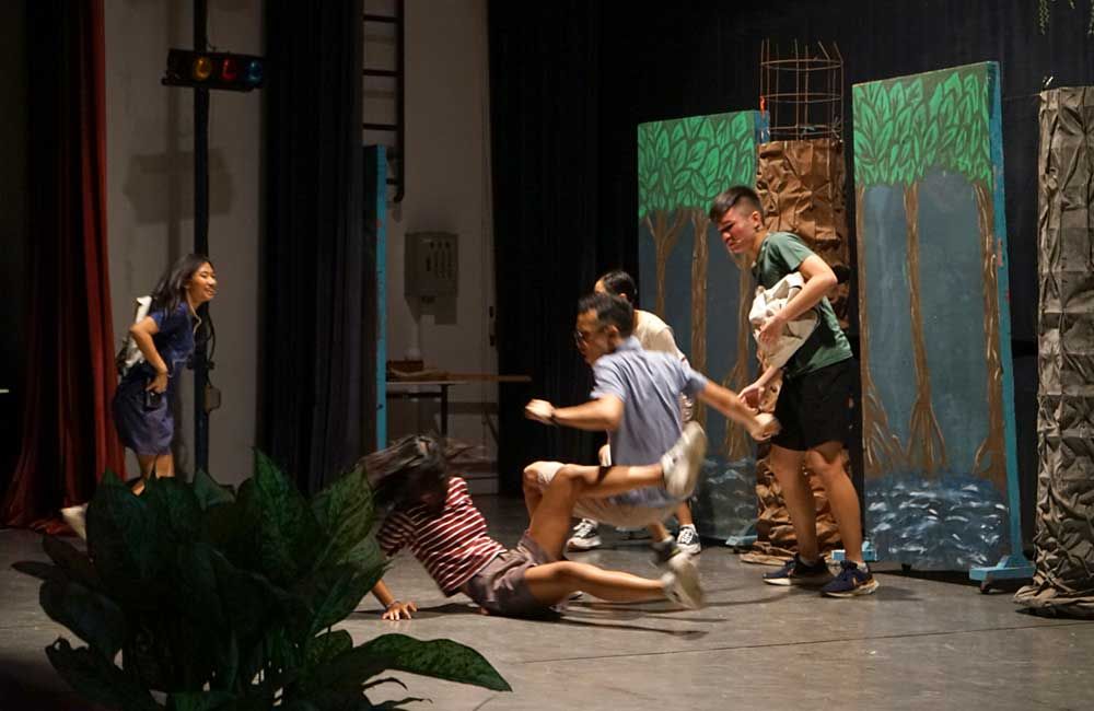 A group of people are playing a game on a stage.